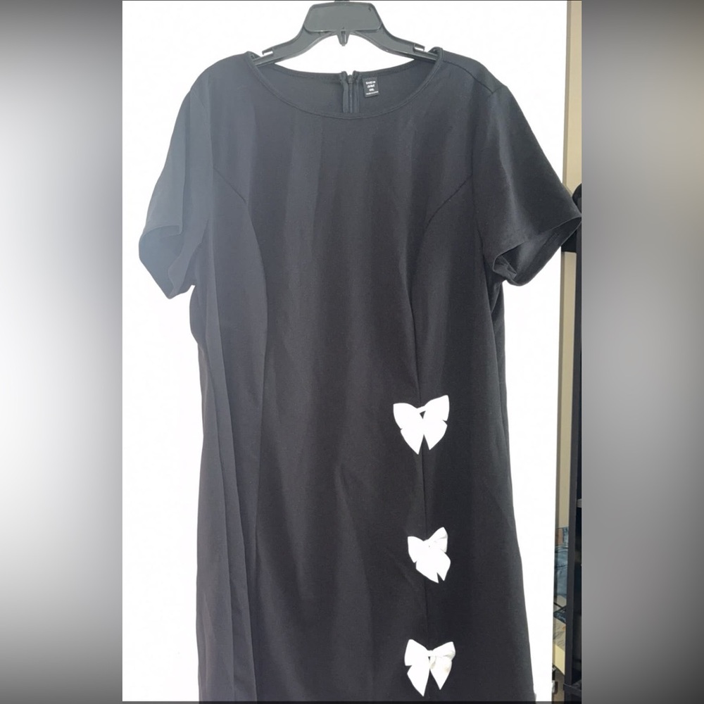 Elegant Black Top with White Bow Accents